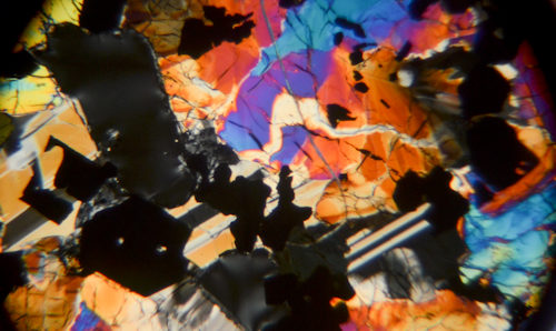 Colourful rock sample viewed under a microscope